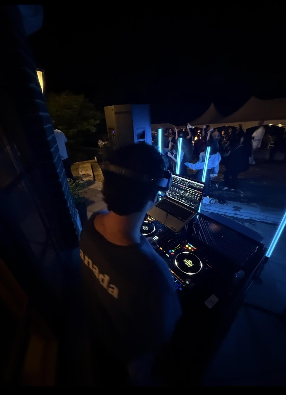 Gabe DJing at a nighttime event